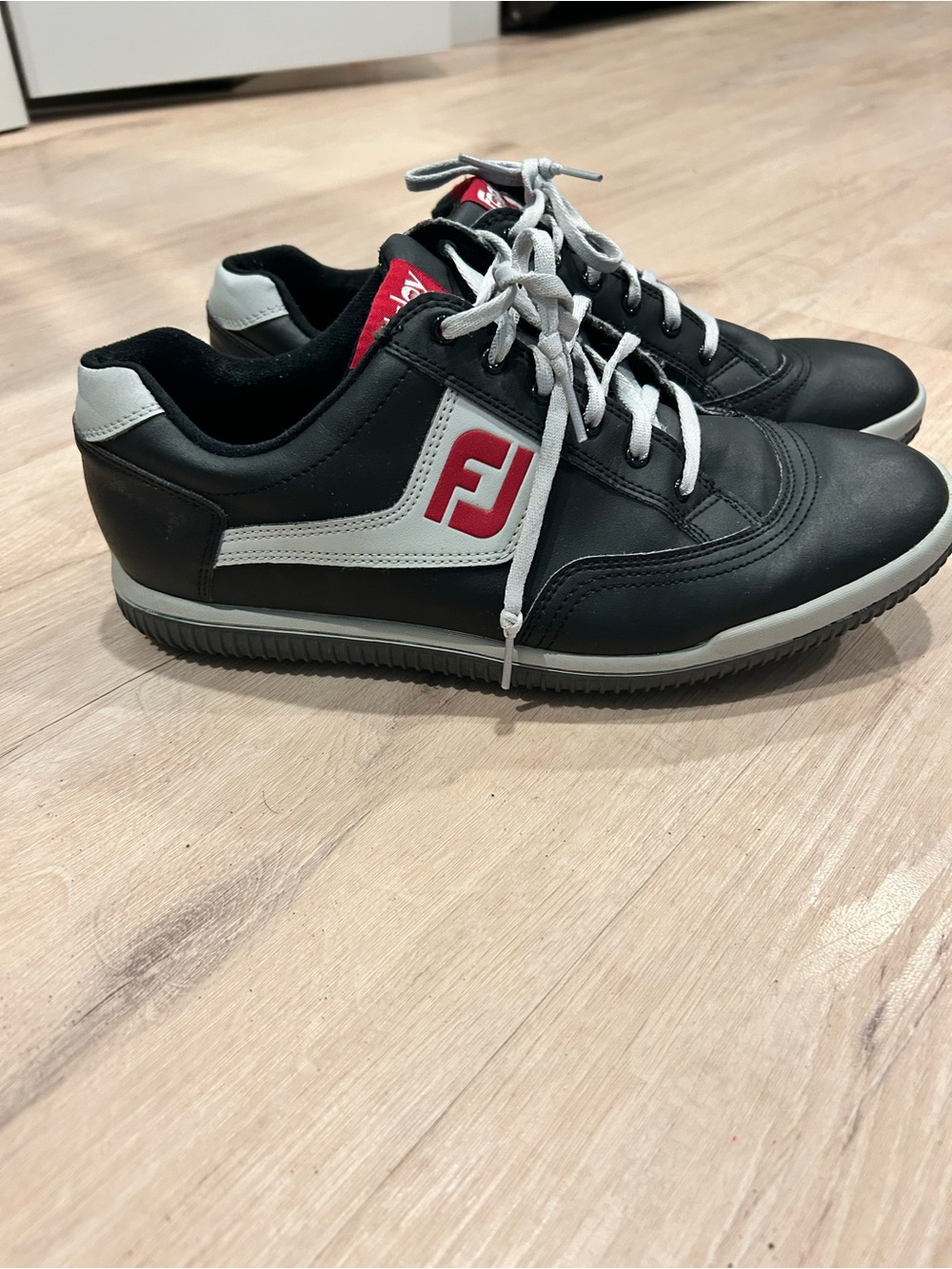 FootJoy Black and White Men's spikeless golf Sneaker with Red Logo